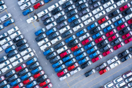 Aerial view new cars for sale stock lot row, New  Cars dealer inventory import export business logistic global.